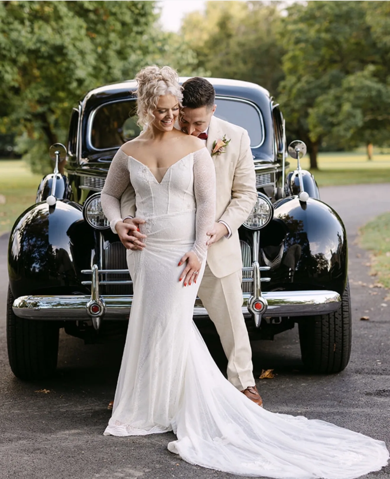 Bride and groom with vintage car